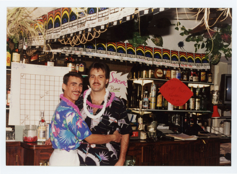 Two men embracing and posing for photo