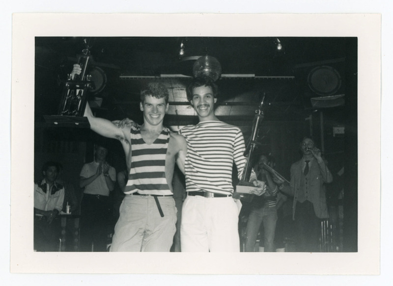 Two people posing with winning trophy