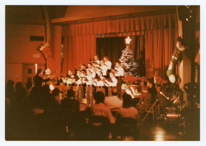 Men singing in choir performance from a distance